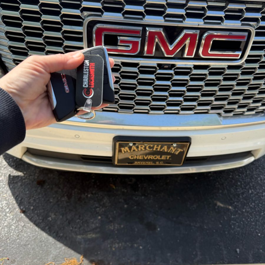 Charleston Locksmith technician cutting and programming a GMC car key fob on-site